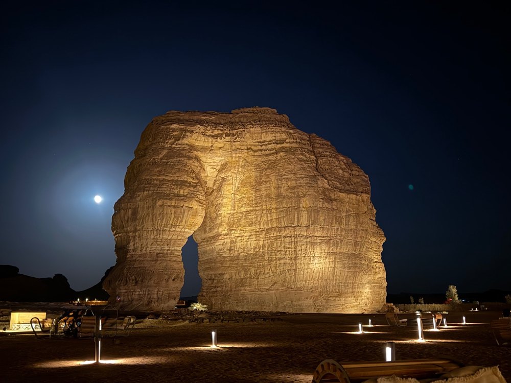 Illuminated desert rock formation at night